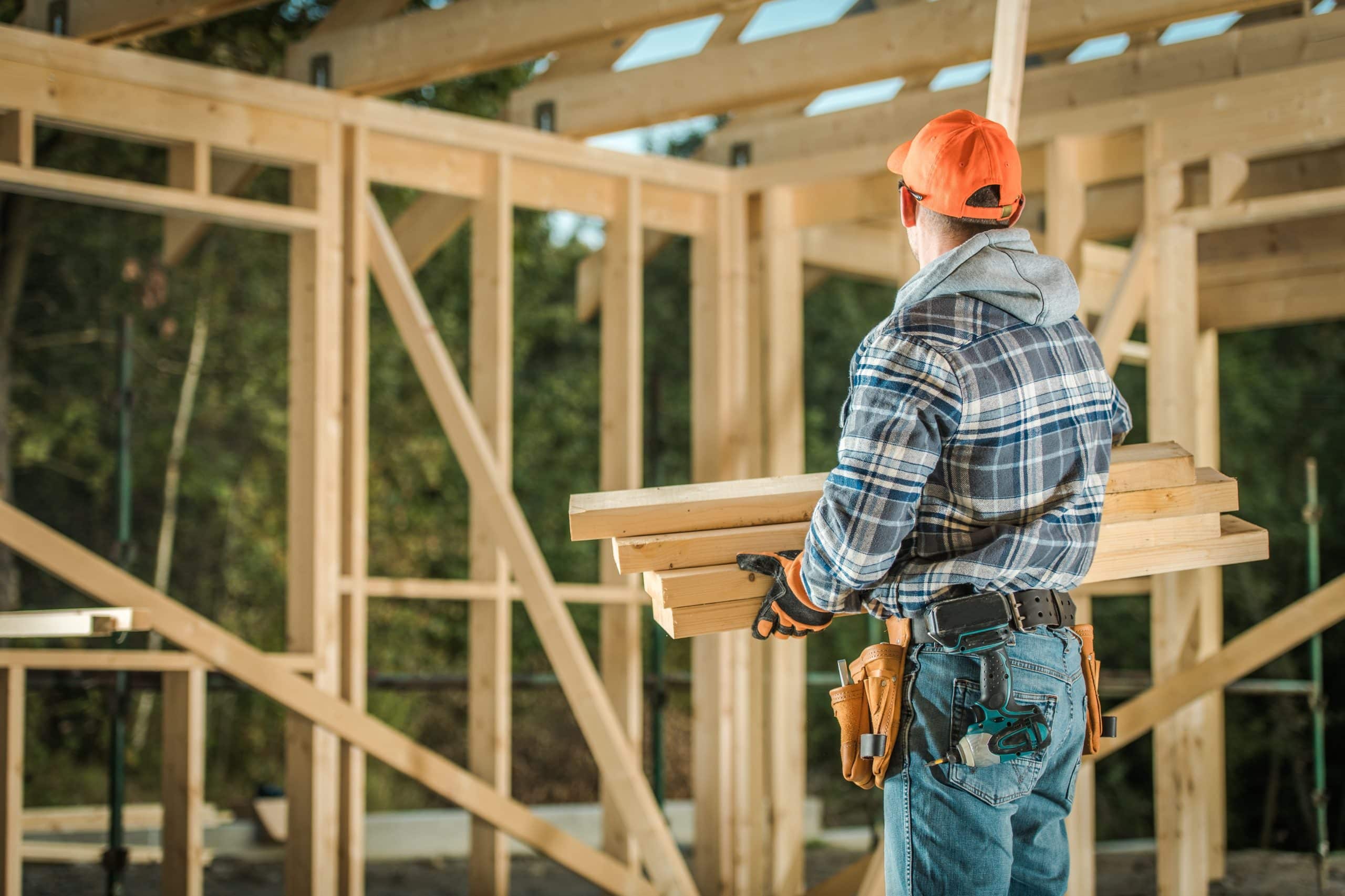 Caucasian Professional Carpenter with Wood Elements. Residential Building Wooden Frame Construction.