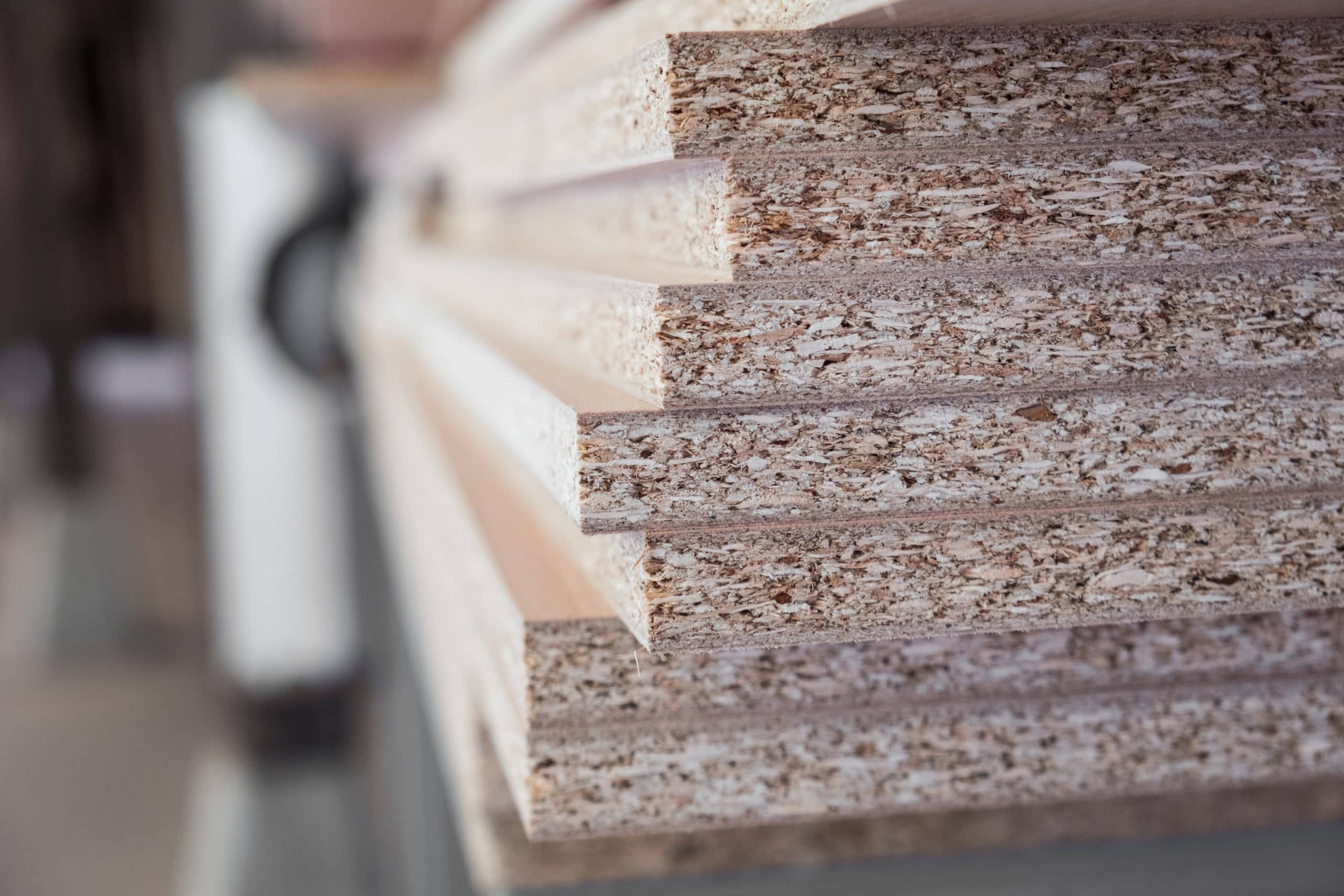 Chipboard pieces stacked in the workshop. Woodworking, carpentry