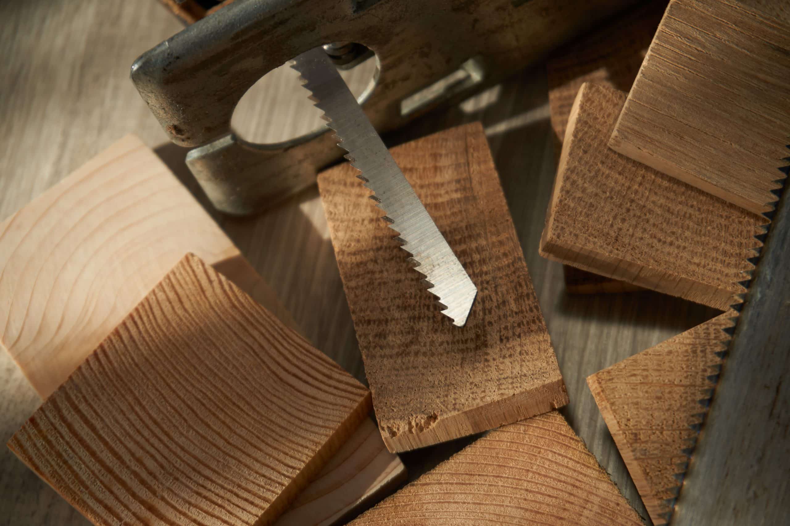 Close up electric jigsaw blade on top of wooden blocks smooth, precise straight and curved cuts concept