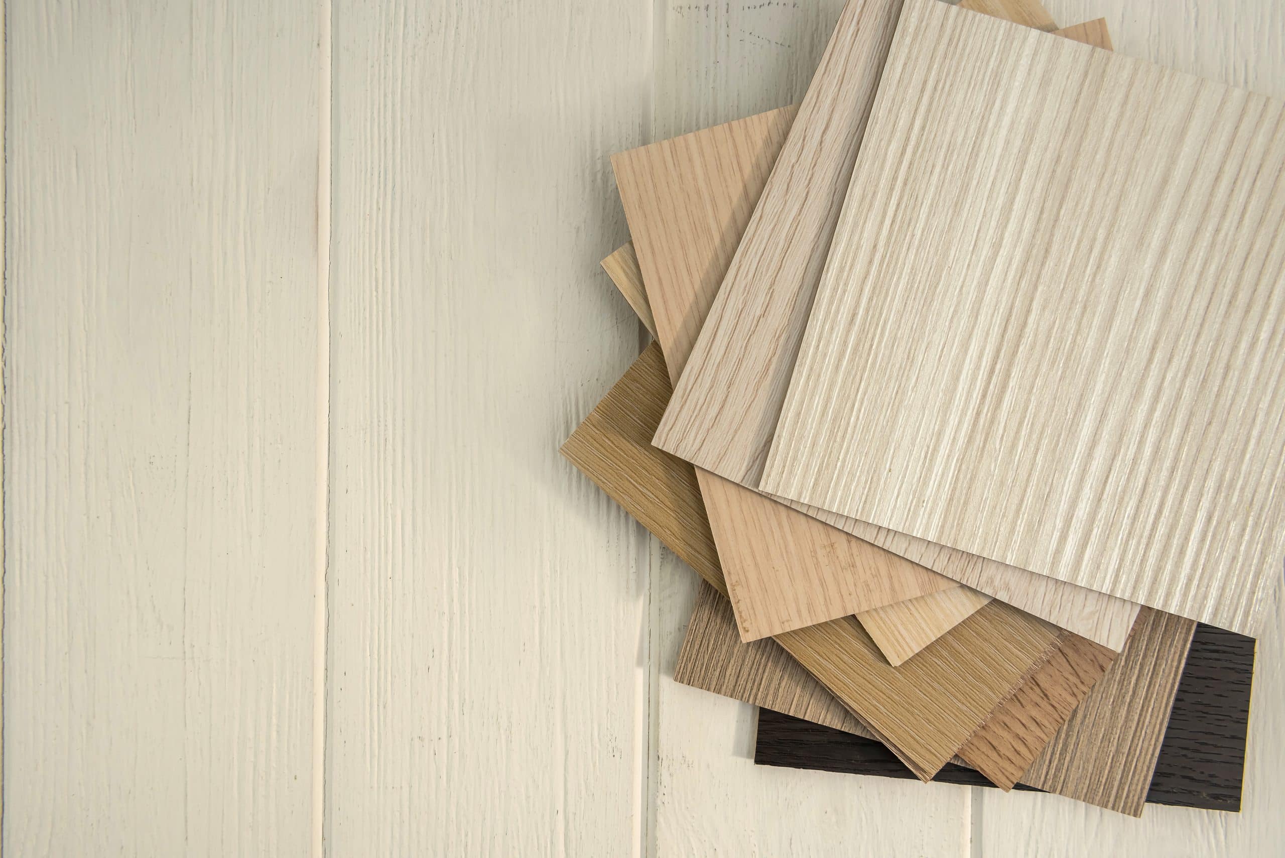 Samples of laminate  planks on wooden desk for new construction or renovation building