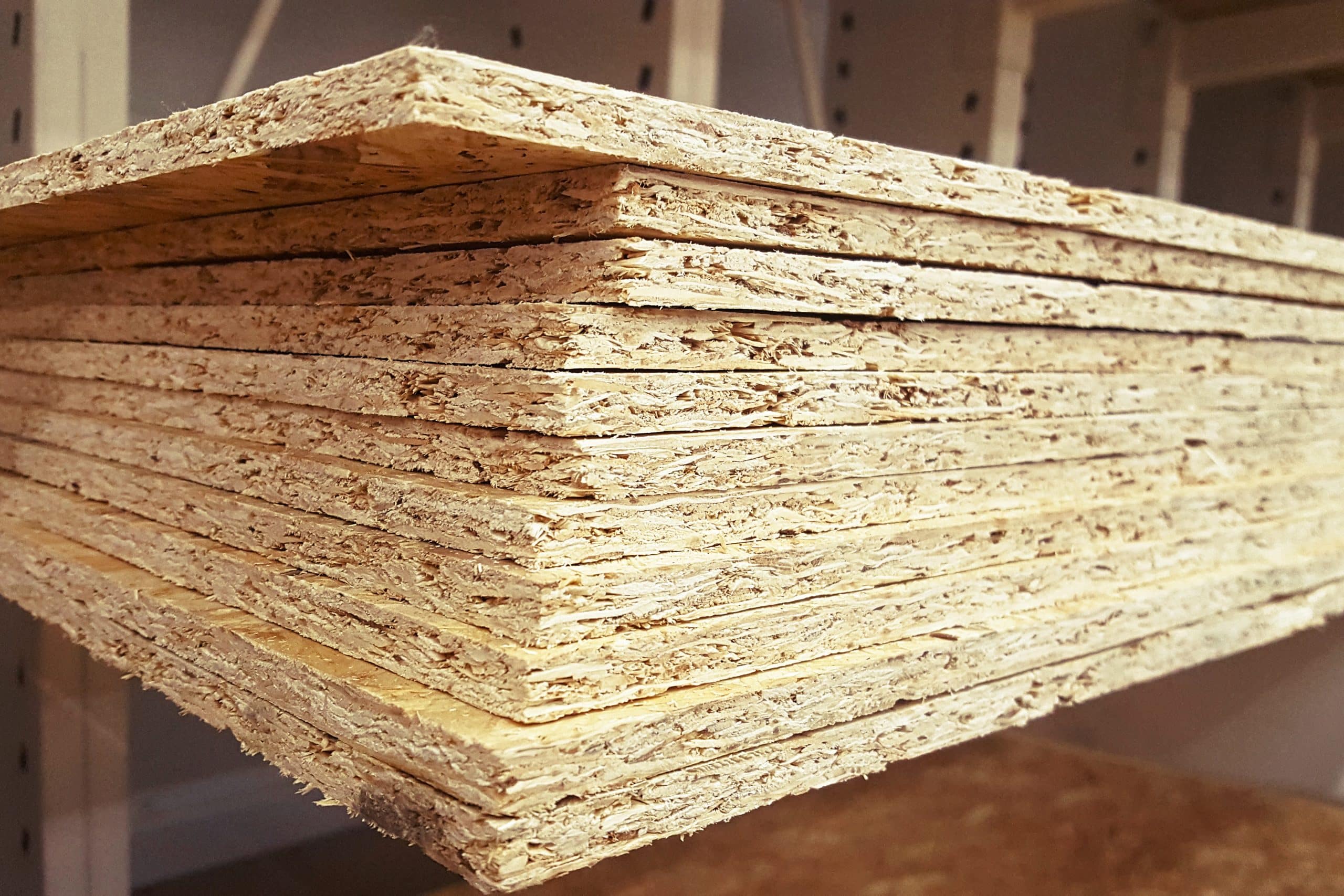 A stack of OSB sheets stacked is sold at the supermarket in the warehouse.
